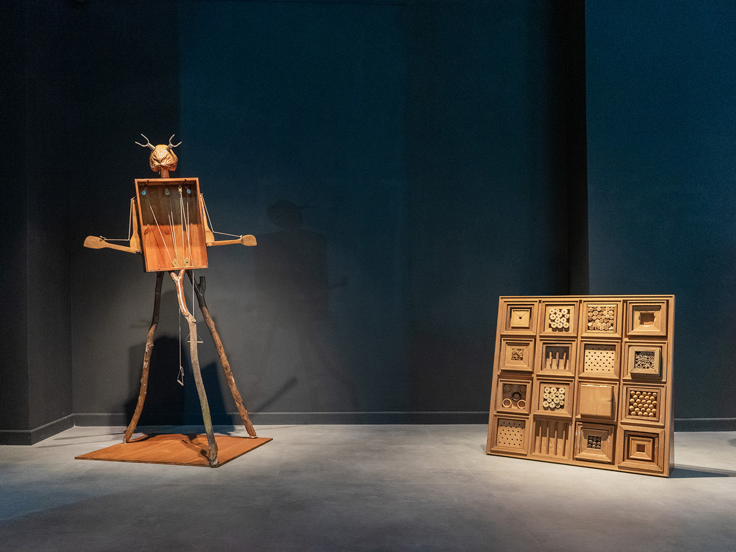 Left: Bird-Activated Scarecrow, 2024, pulley, metal, seeds, recycled wood. Right: Wood You Puzzle, 2024, wood, various natural materials