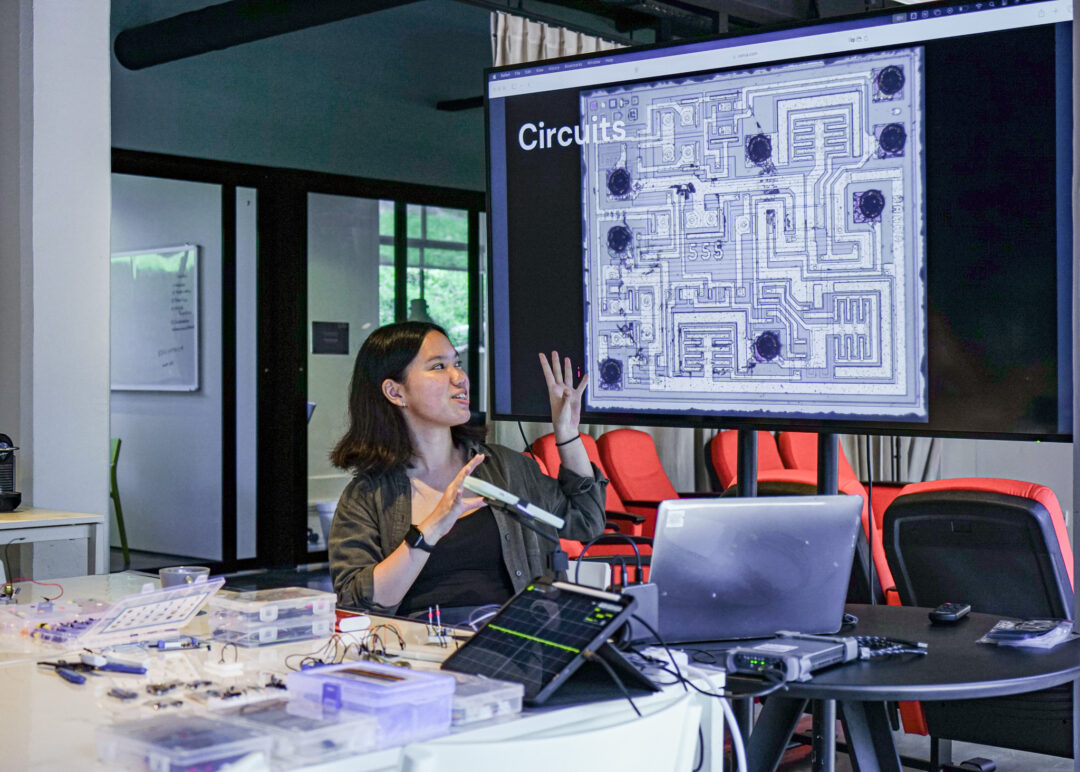 A woman giving a lecture on electronics