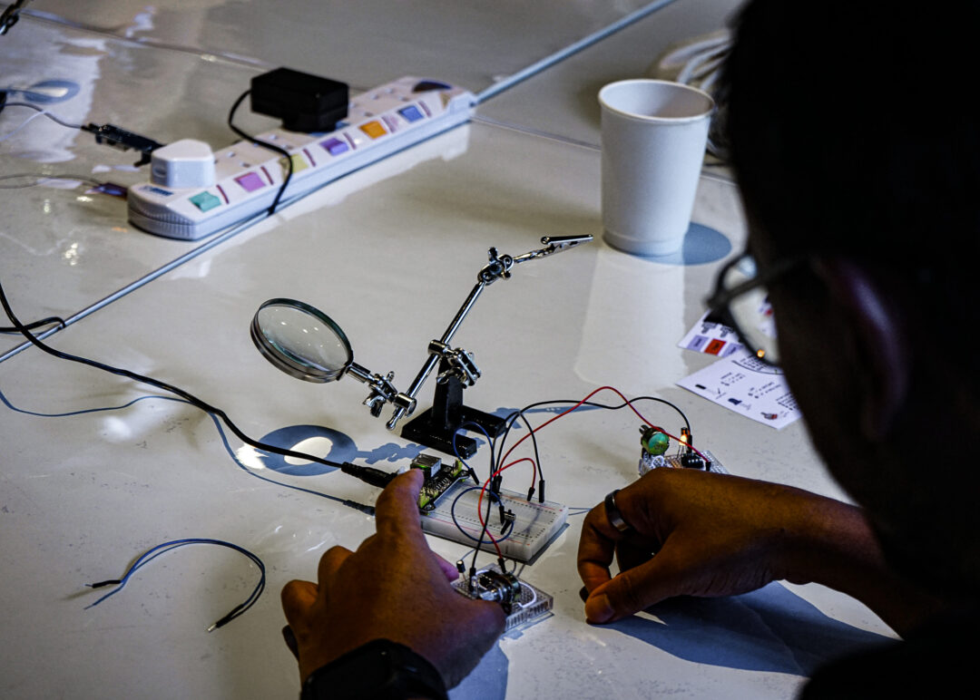 Hands of man tinkering with electronics