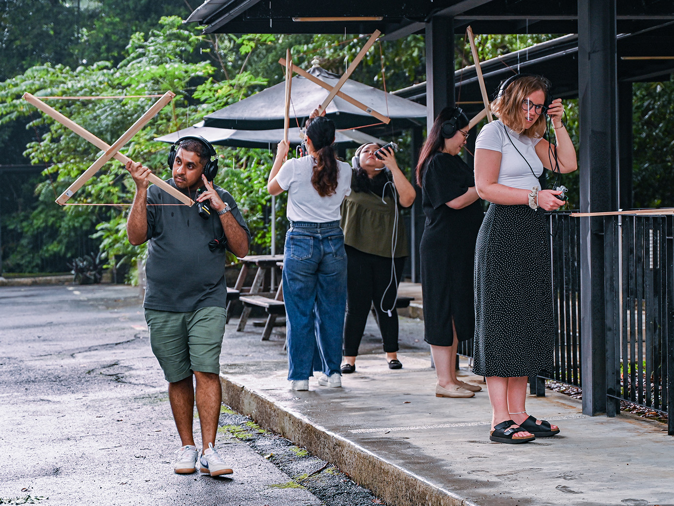 People with antennas listening to radio waves in a forest