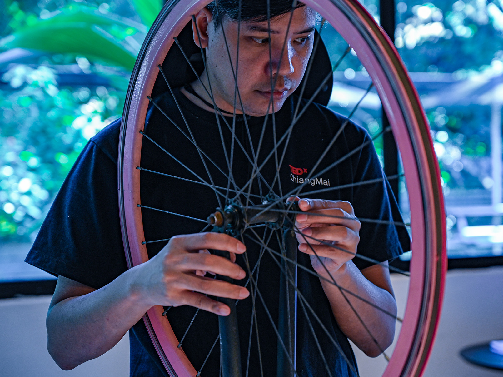a man holding a bicycle wheel